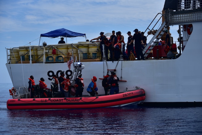Haitians are transferred from Coast Guard Cutter Campbell's small boat to the cutter approximately 20 miles south of Turks and Caicos