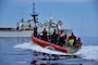 Haitians are transferred from Coast Guard Cutter Campbell's small boat to the cutter approximately 20 miles south of Turks and Caicos