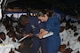 A Coast Guard Cutter Campbell crew member and Haitian Coast Guard member speak with Haitians on the deck of Coast Guard Cutter Campbell before being repatriated to Haiti in the Windward Passage