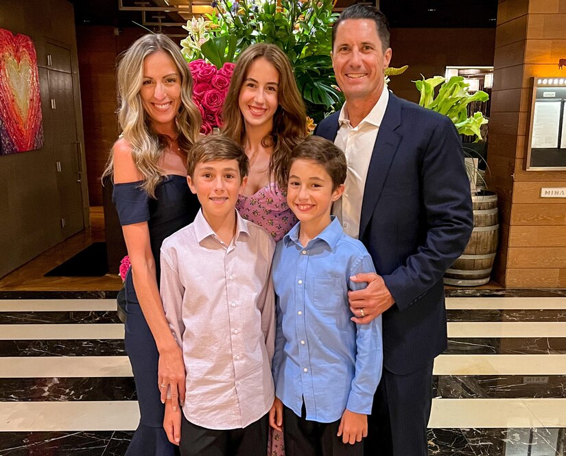 A dressed-up family of five poses for a photo.