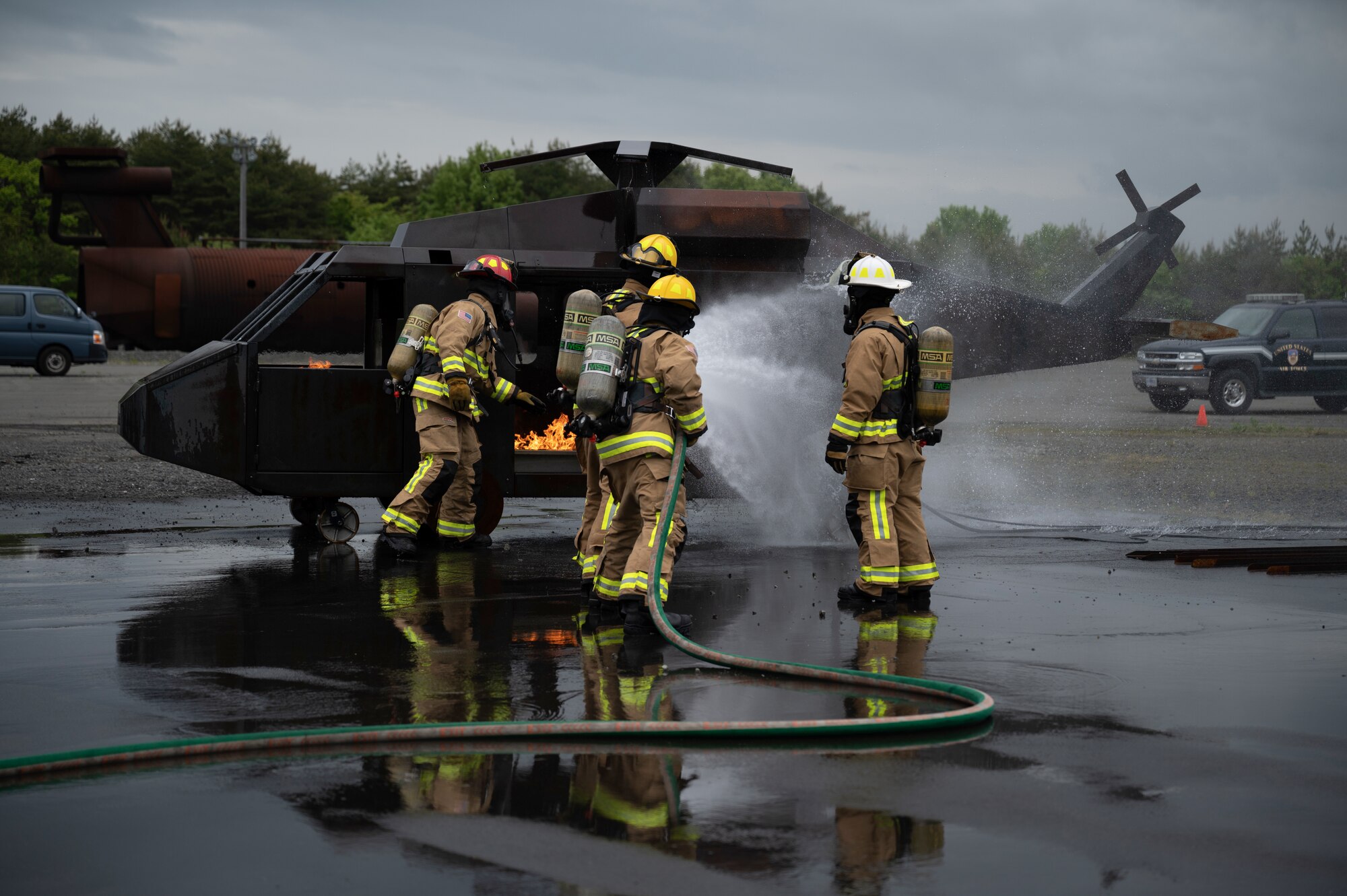 Firefighters put out a helicopter fire.