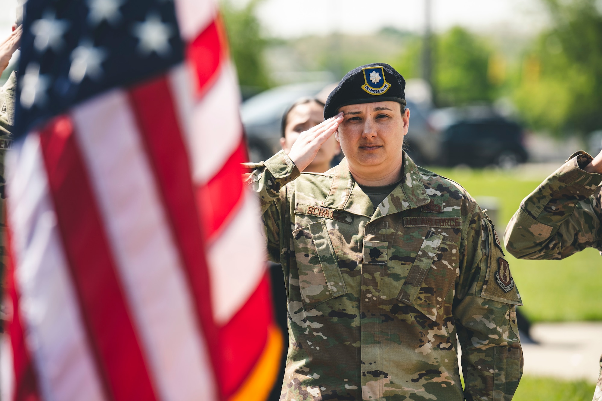 The commander of 88 Security Forces Squadron salutes the flag.