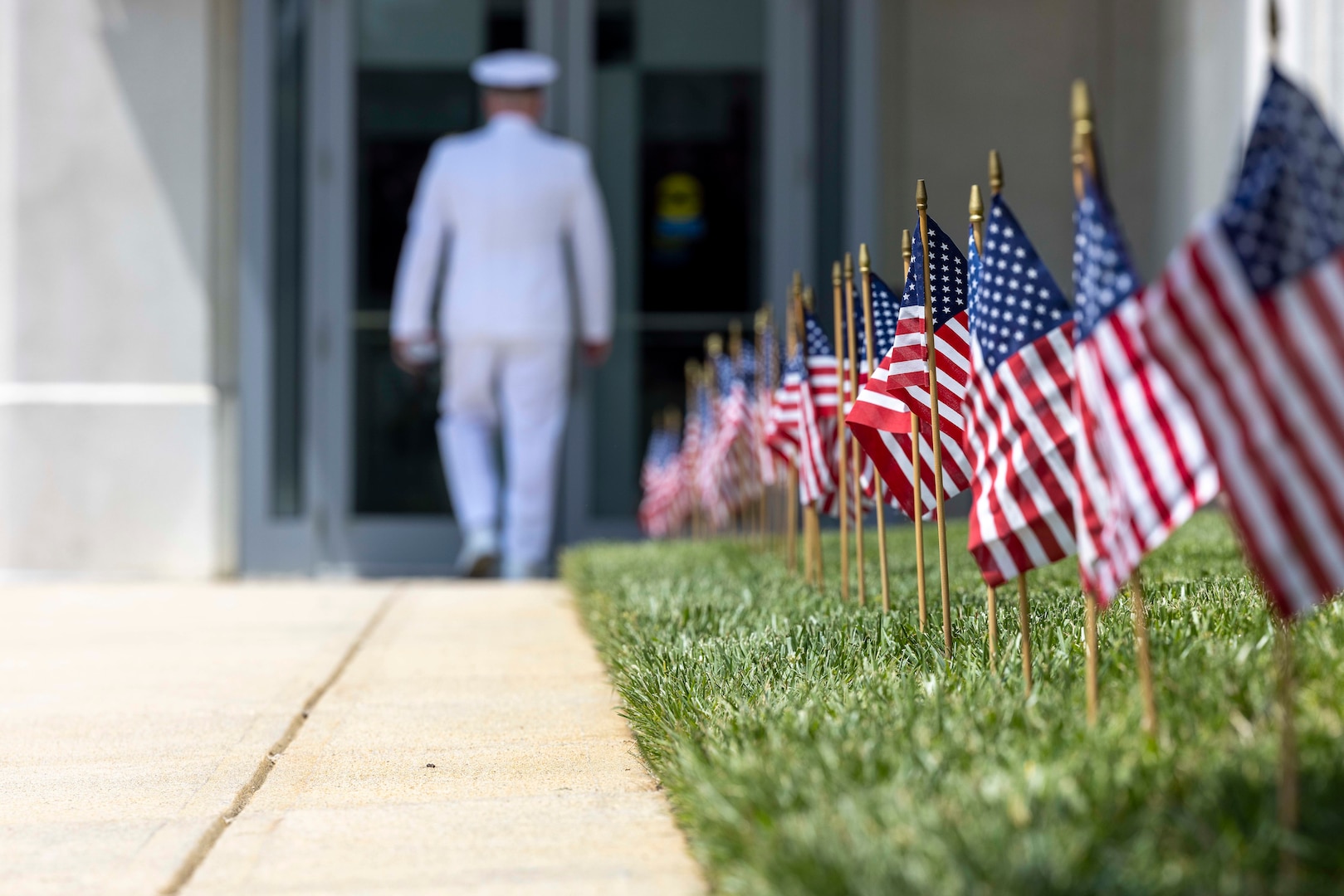 Miniature American Flags begin to sway gently in the morning air as Cmdr. Michael Smith, Naval Surface Warfare Center, Carderock Division’s Executive Officer, arrives at the change-of-command ceremony held in West Bethesda, Md., on May 12. (U.S. Navy photo by Devin Pisner)