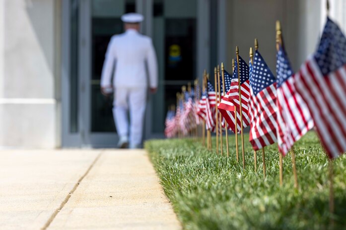 Miniature American Flags begin to sway gently in the morning air as Cmdr. Michael Smith, Naval Surface Warfare Center, Carderock Division’s Executive Officer, arrives at the change-of-command ceremony held in West Bethesda, Md., on May 12. (U.S. Navy photo by Devin Pisner)