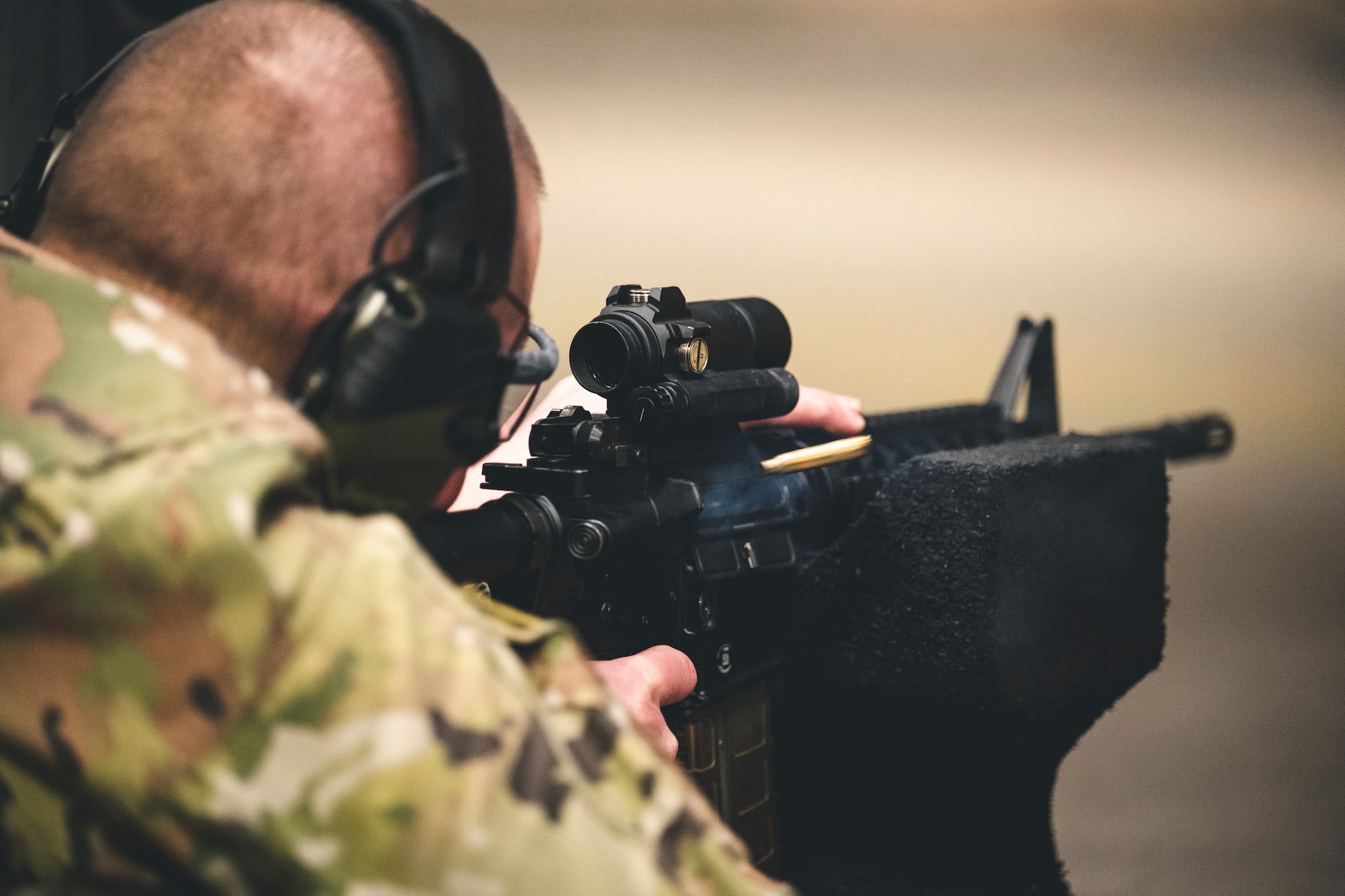 An Airman fires a weapon