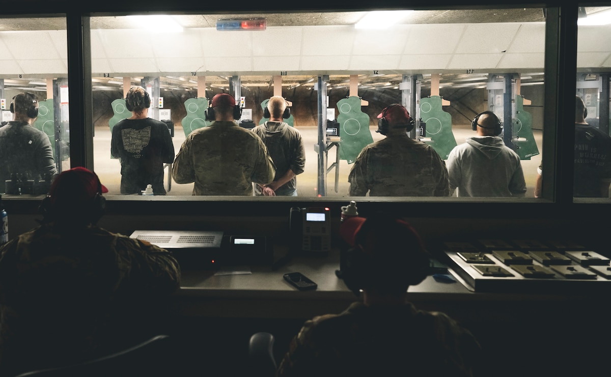 Competitors stand ready to fire their weapon