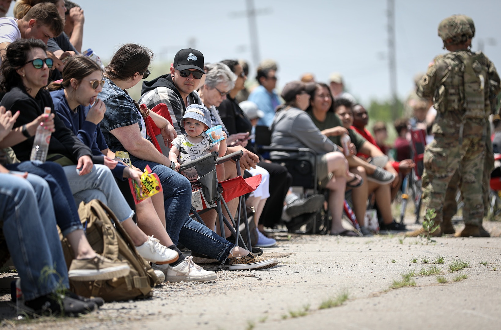 Families and friends of Soldiers assigned to 1st Battalion, 160th Field Artillery Regiment sit and wait as their loved ones prepare for a live-fire demonstration using M119 and M777 howitzers on May 20, 2023 at Fort Sill, Oklahoma. The live-fire event was a family day hosted by the artillery unit as a way to strengthen the bonds between the Soldiers and their families. (Oklahoma National Guard photo by Pfc. Anthony Ackah-Mensah)