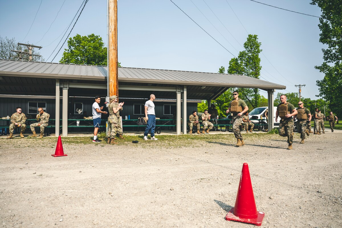 Marines run across the finish line during the Defender Challenge