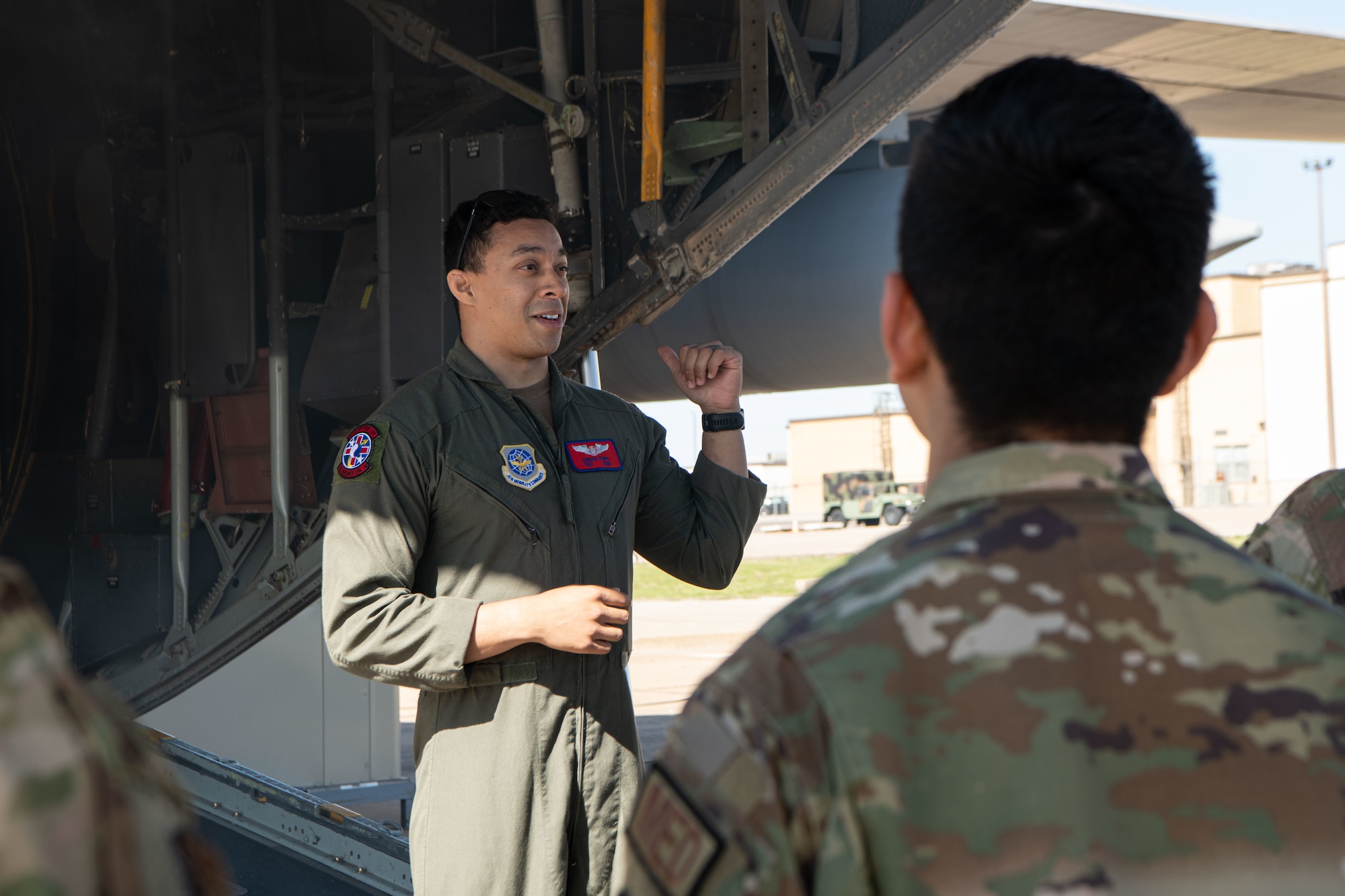 Airman briefing others in front of aircraft