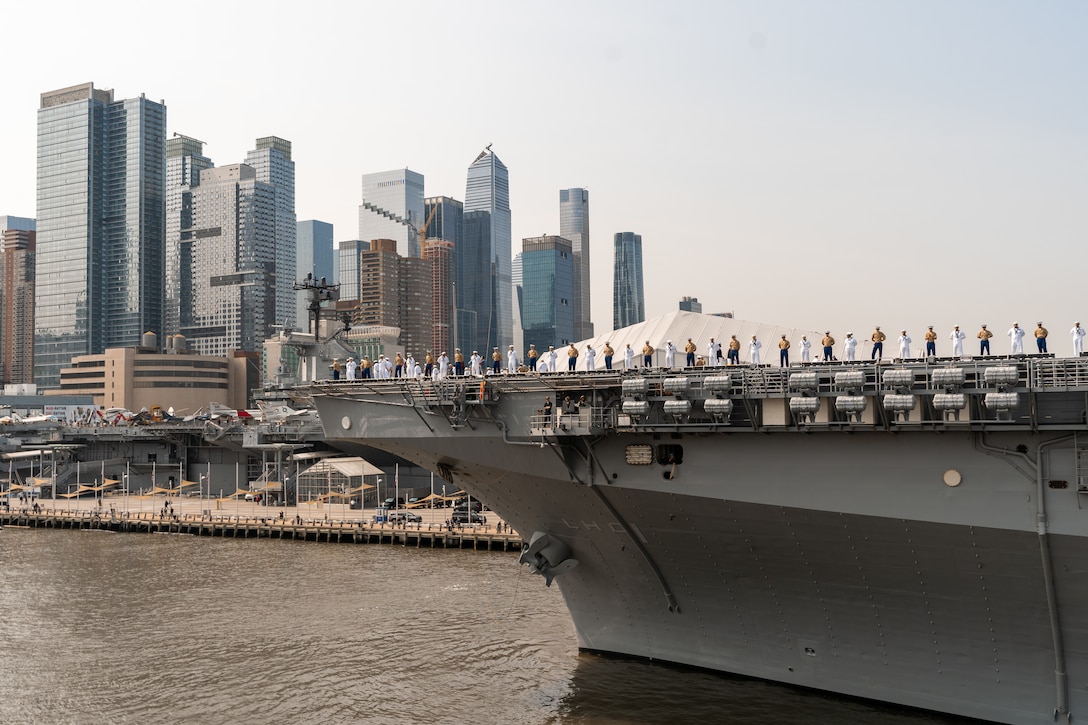 The amphibious assault ship USS Wasp (LHD 1) is escorted into Pier 88 in New York City during the Parade of Ships as part of Fleet Week New York (FWNY), May 24, 2023. FWNY 2023 provides an opportunity for the American public to meet Sailors, Marines, and Coast Guardsmen and see first-hand the latest capabilities of today’s maritime services. (U.S. Marine Corps photo by Sgt. Juan Carpanzano)