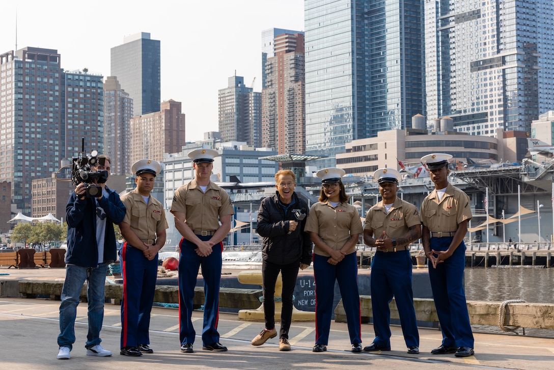 U.S. Marines attached to Special Purpose Marine Air-Ground Task Force – New York, pose for a photo with CBS news anchor John Elliot after being interviewed during the Parade of Ships as part of Fleet Week New York (FWNY), May 24, 2023. FWNY 2023 provides an opportunity for the American public to meet Sailors, Marines, and Coast Guardsmen and see first-hand the latest capabilities of today’s maritime services. (U.S. Marine Corps photo by Sgt. Juan Carpanzano)