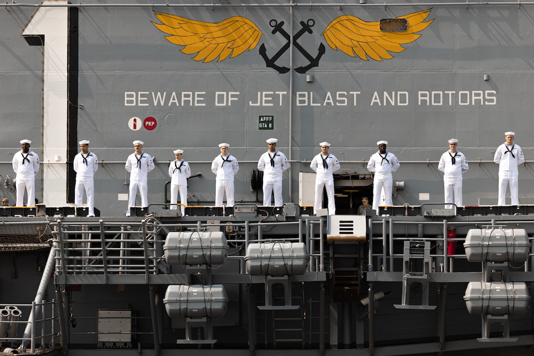 U.S. Navy Sailors man the rails of the amphibious assault ship USS Wasp (LHD 1) as it is escorted into Pier 88 in New York City during the Parade of Ships as part of Fleet Week New York (FWNY), May 24, 2023. FWNY 2023 provides an opportunity for the American public to meet Sailors, Marines, and Coast Guardsmen and see first-hand the latest capabilities of today’s maritime services. (U.S. Marine Corps photo by Sgt. Juan Carpanzano)