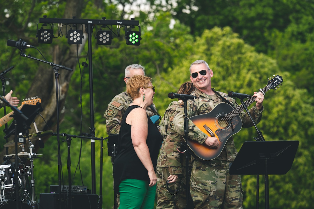 People sing together on a stage.