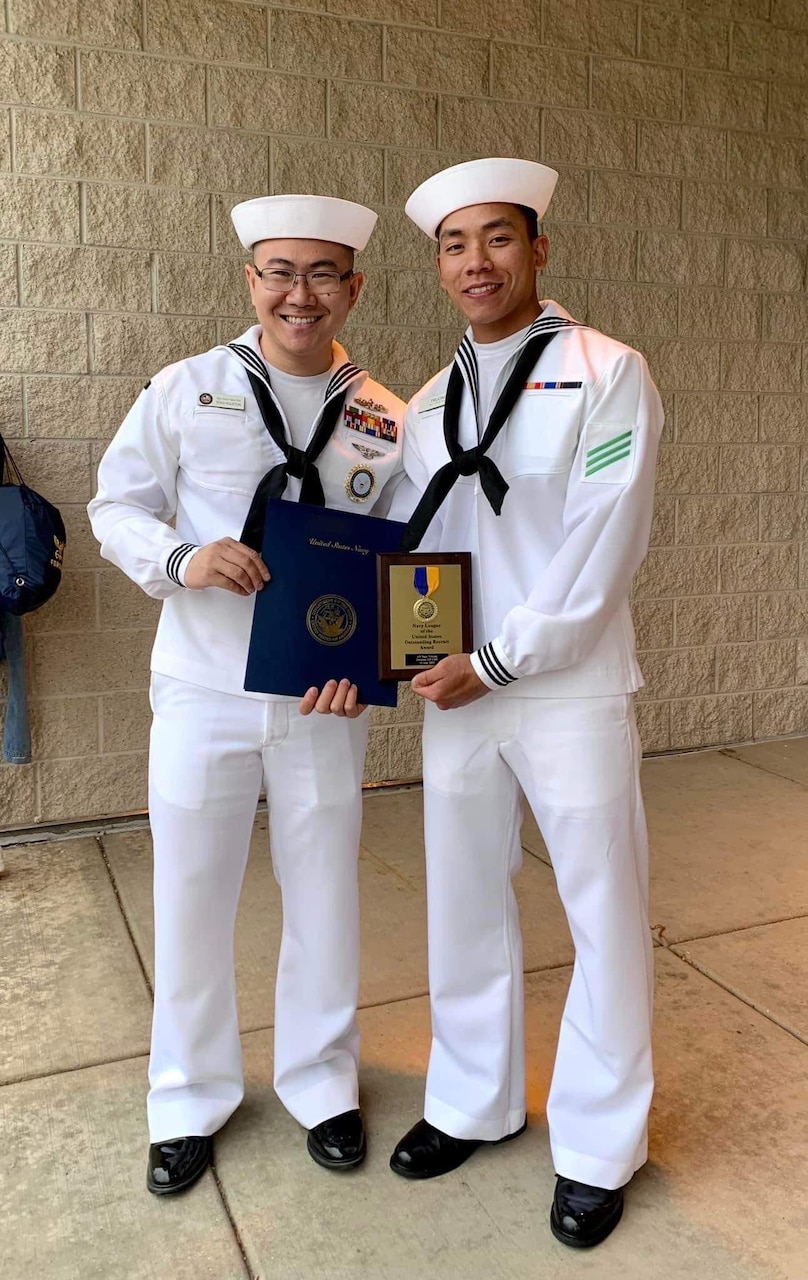 RS2 Thuy Nguyen stands alongside a Sailor that he recruited into the Navy at NTAG Houston station