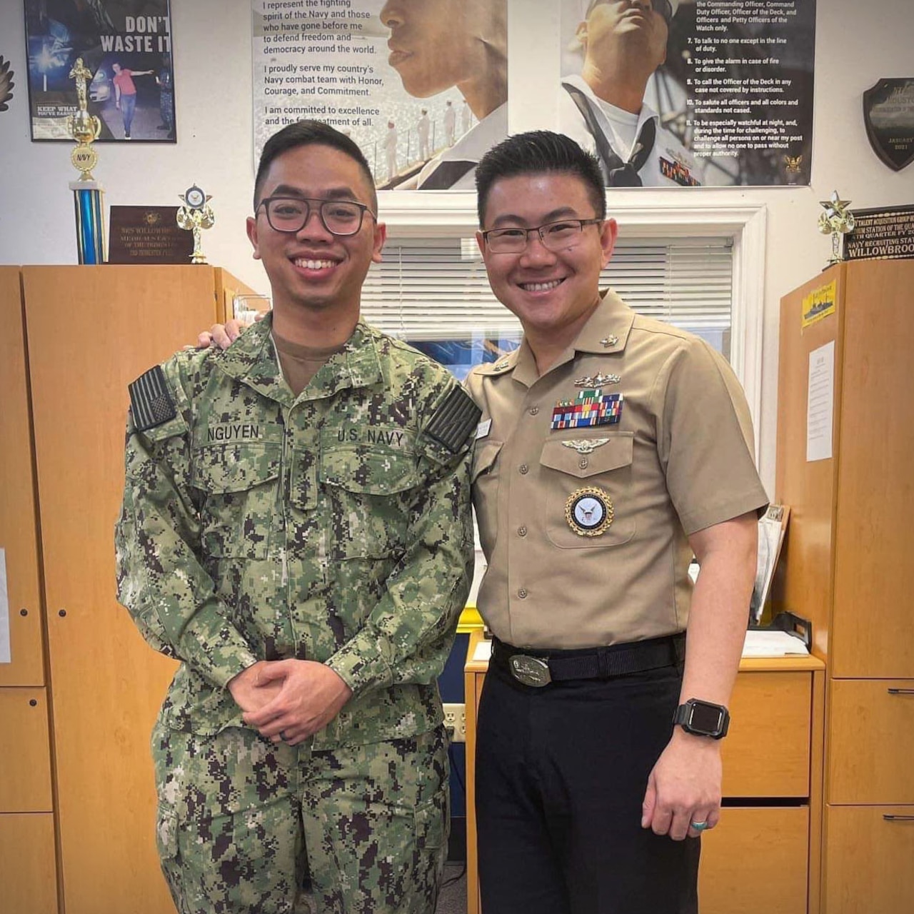 RS2 Thuy Nguyen stands alongside a Sailor that he recruited into the Navy at NTAG Houston station