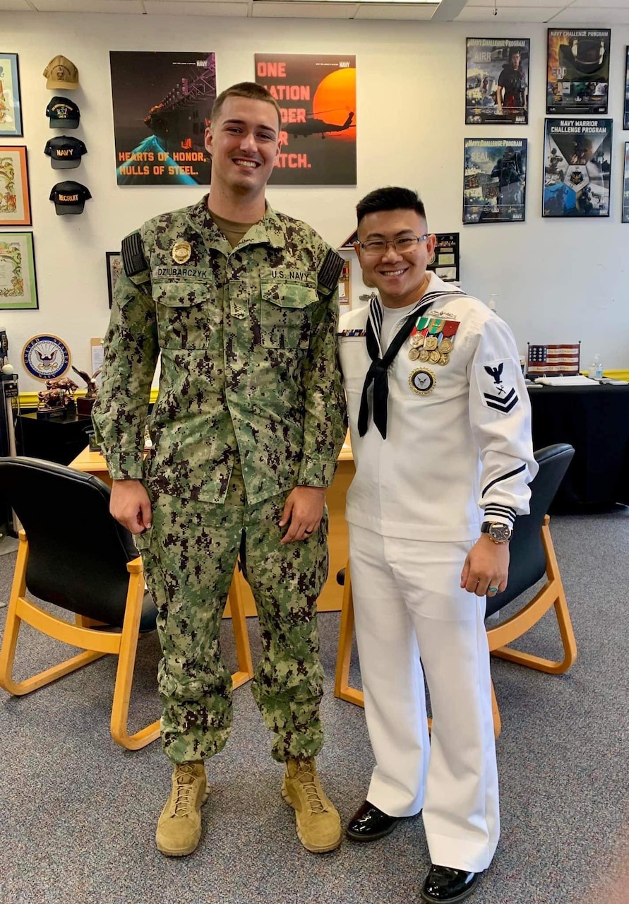 RS2 Thuy Nguyen stands alongside a Sailor that he recruited into the Navy at NTAG Houston station