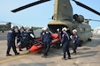 Members of the Montgomery County Urban Search and Rescue Team practice loading a water rescue boat and equipment into a CH-47 Chinook helicopter from Bravo Co., 2-104th General Support Aviation Battalion, 28th Expeditionary Combat Aviation Brigade May 18, 2023, at Fort Indiantown Gap, Pa. The training was part of an extreme weather exercise coordinated by the Pennsylvania Emergency Management Agency. (Pennsylvania National Guard photo by Brad Rhen)