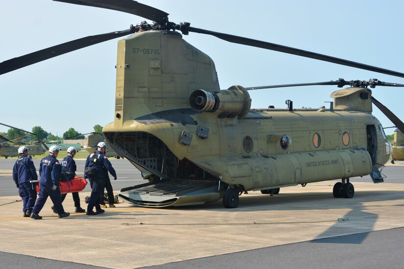 Members of the Montgomery County Urban Search and Rescue Team practice loading an inflatable boat and equipment into a CH-47 Chinook helicopter from Bravo Co., 2-104th General Support Aviation Battalion, 28th Expeditionary Combat Aviation Brigade May 18, 2023, at Fort Indiantown Gap, Pa. The training was part of an extreme weather exercise coordinated by the Pennsylvania Emergency Management Agency. (Pennsylvania National Guard photo by Brad Rhen)