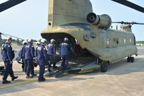 Members of the Montgomery County Urban Search and Rescue Team practice loading an inflatable boat and equipment into a CH-47 Chinook helicopter from Bravo Co., 2-104th General Support Aviation Battalion, 28th Expeditionary Combat Aviation Brigade May 18, 2023, at Fort Indiantown Gap, Pa. The training was part of an extreme weather exercise coordinated by the Pennsylvania Emergency Management Agency. (Pennsylvania National Guard photo by Brad Rhen)