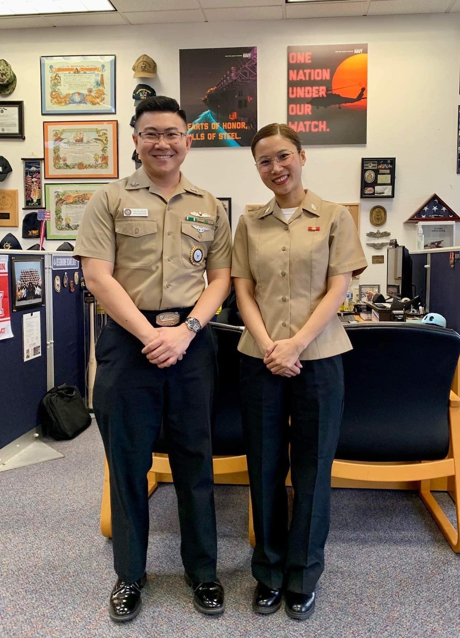 RS2 Thuy Nguyen stands alongside a Sailor who he recruited at NTAG Houston.