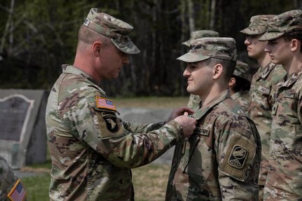 Command Sgt. Maj. John Phlegar, left, the state command sergeant major of the Alaska Army National Guard, pins the Army Commendation Medal on the 2023 Soldier of the Year, Spc. Adam Macro, a military police Soldier from Alpha Company, 49th Missile Defense Battalion during the Best Warrior Competition awards ceremony held at Camp Carroll, Alaska, May 21, 2023. Throughout the week of May 16, 2023, the Best Warrior Competition tested Soldiers on their physical and mental readiness as well as their knowledge of Army doctrine and common warrior tasks.