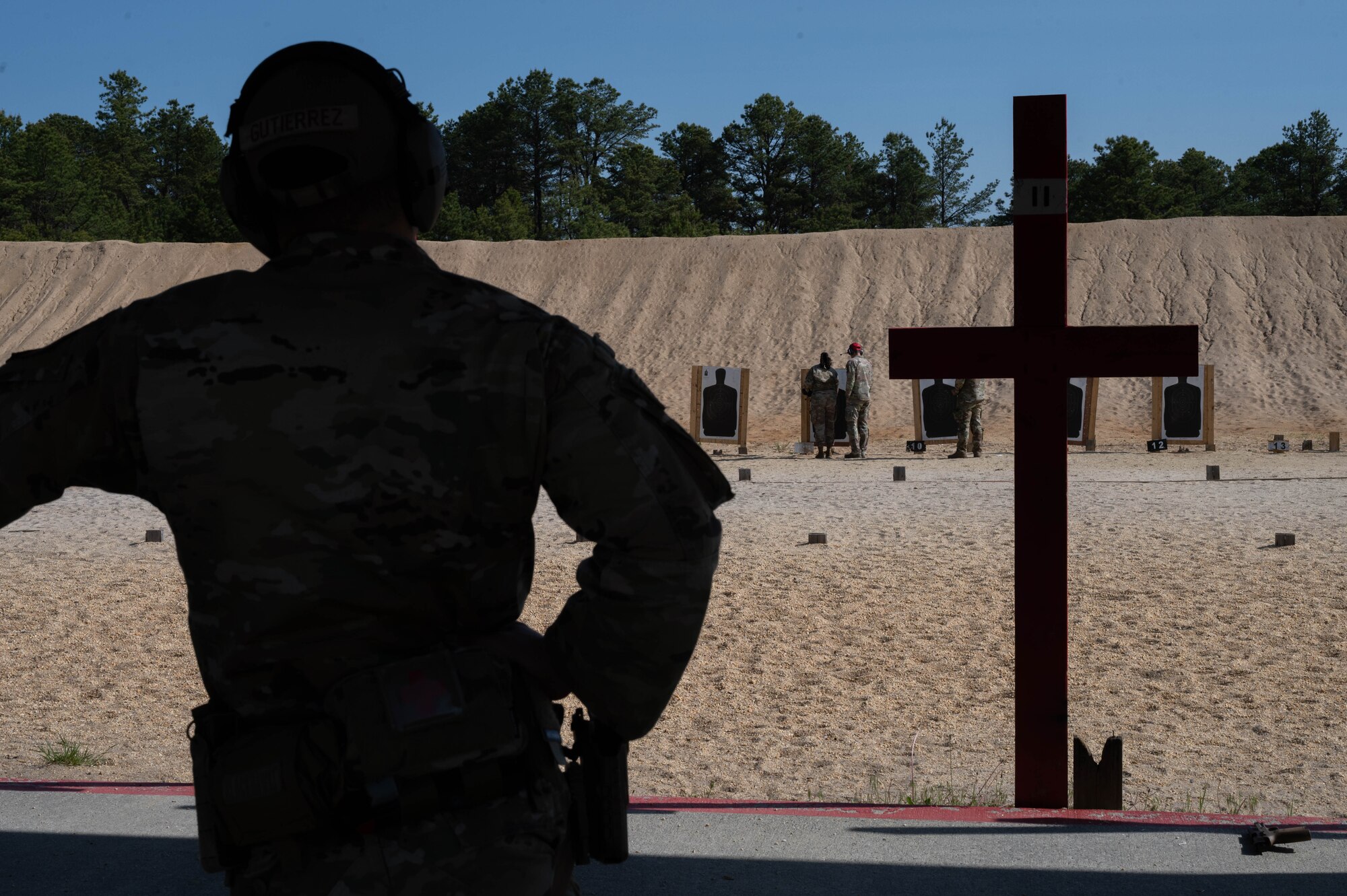 An Airman reviews his marksmanship accuracy during the Excellence-In Competition for Police Week at Joint Base McGuire-Dix-Lakehurst, N.J. May 15, 2023. National Police Week is observed annually, and it honors the courageous law enforcement officers who made the ultimate sacrifice in the line of duty, while ensuring the safety and protection of others. (U.S. Air Force photo by Senior Airman Faith Iris MacIlvaine)