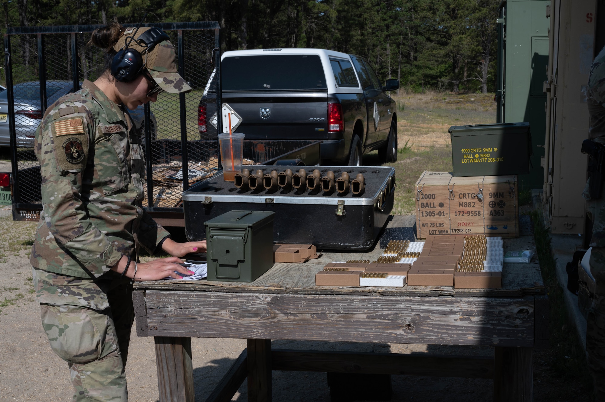 An Airman prepares the range for the start of the Excellence-In Competition during Police Week at Joint Base McGuire-Dix-Lakehurst, N.J. May 15, 2023. National Police Week is observed annually, and it honors the courageous law enforcement officers who made the ultimate sacrifice in the line of duty, while ensuring the safety and protection of others. (U.S. Air Force photo by Senior Airman Faith Iris MacIlvaine)