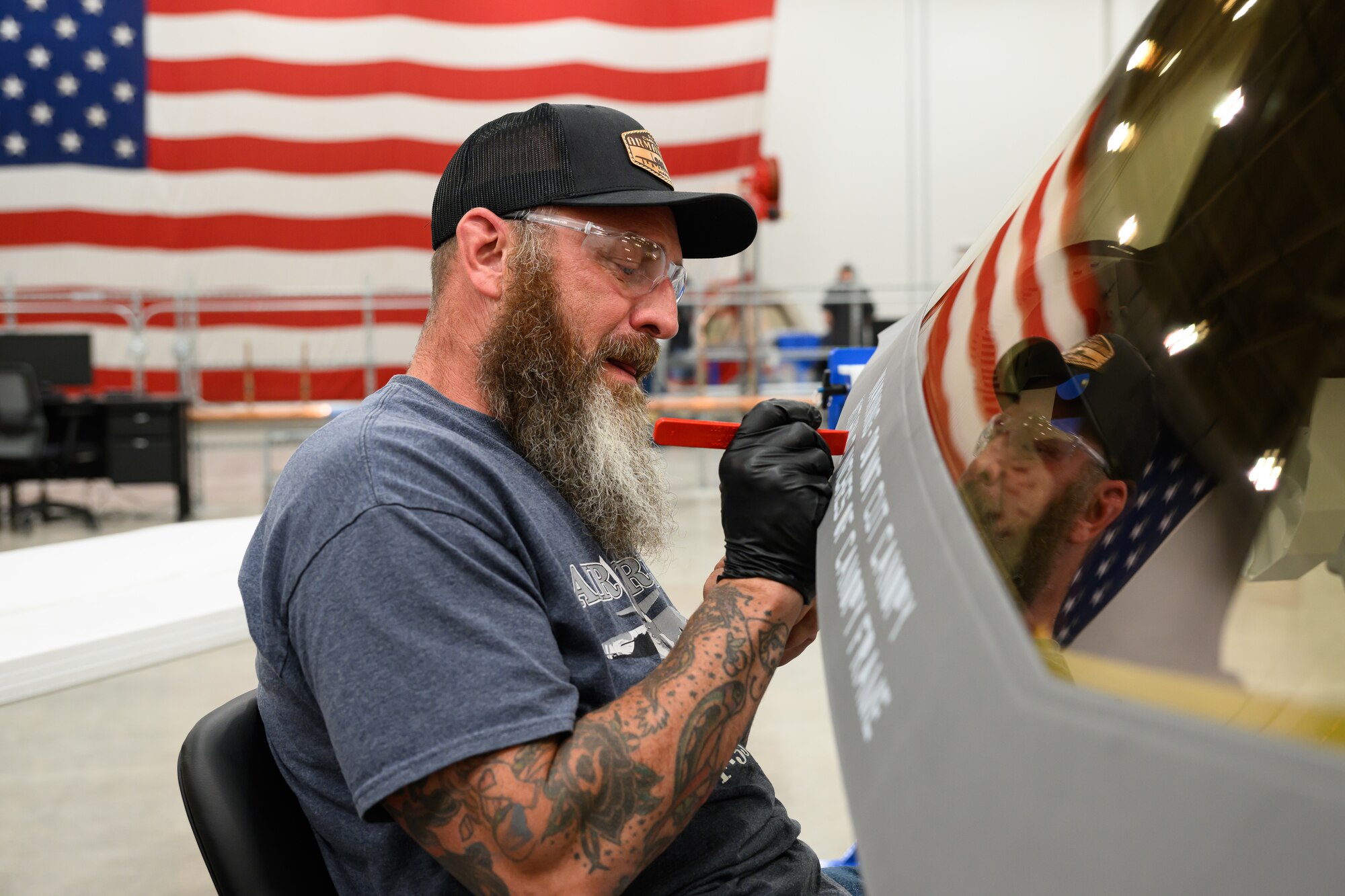 A man works on an F-35 canopy at Hill Air Force Base