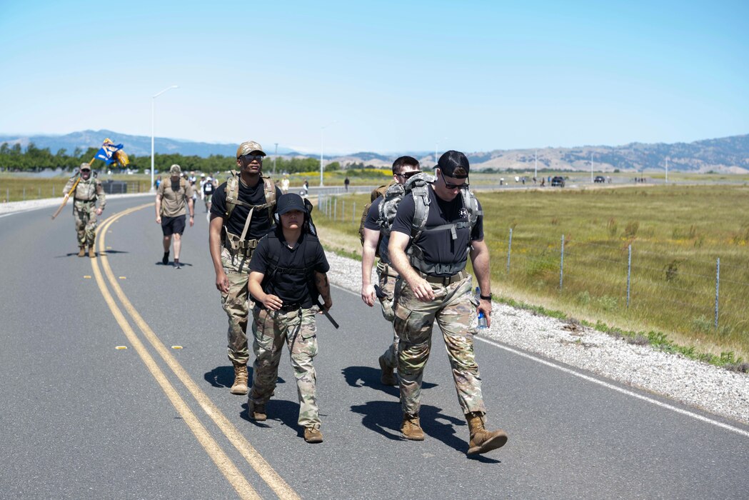 Airmen walk down a road.