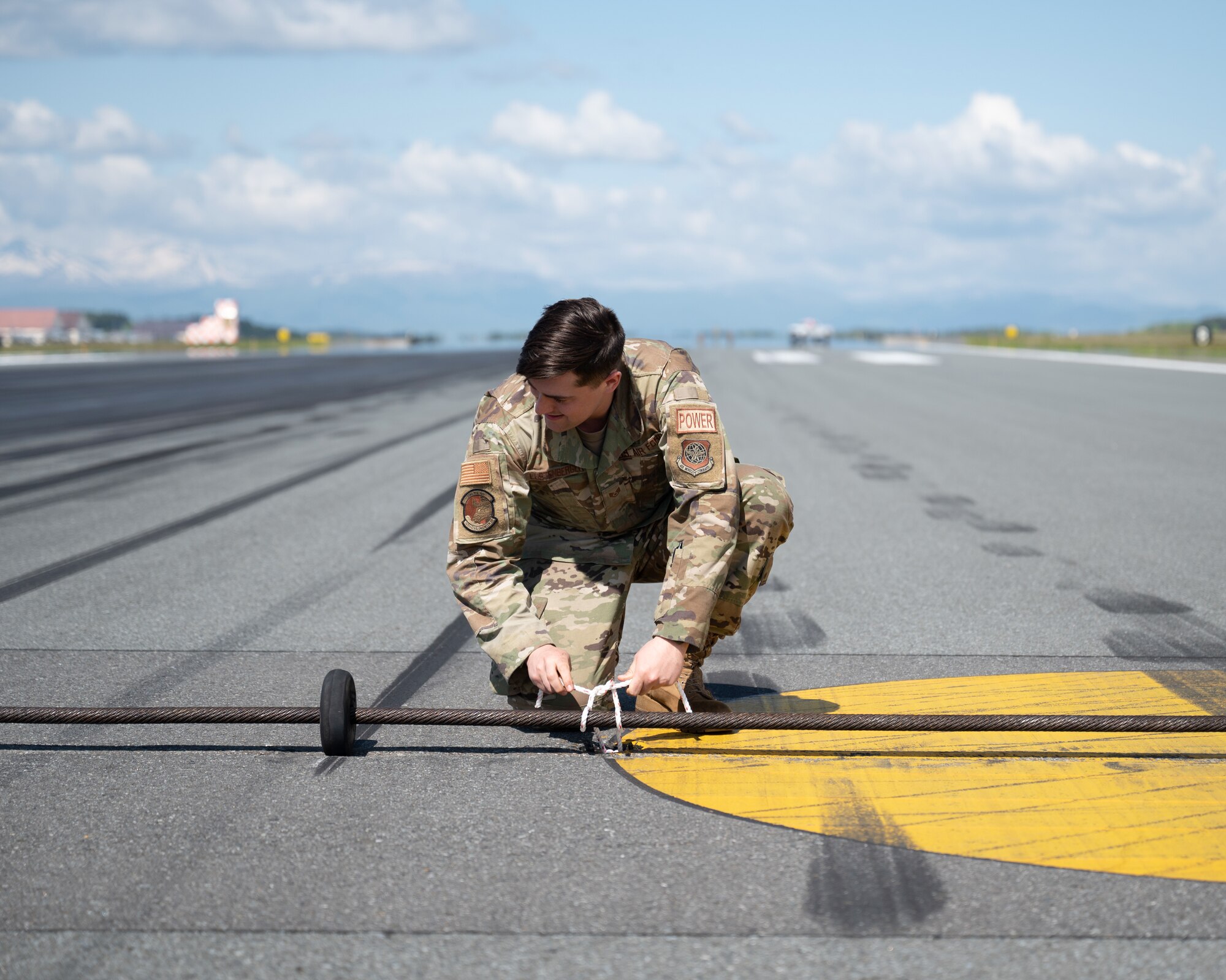 Airmen ties down aircraft arresting systems