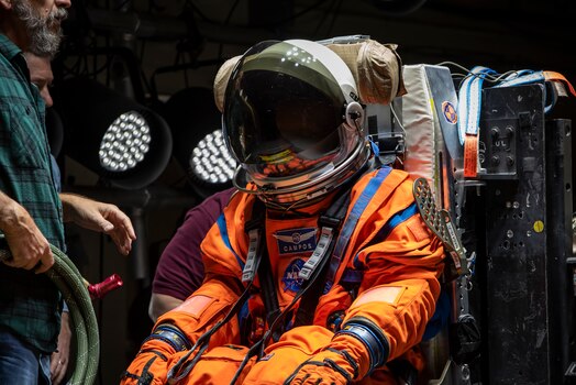  The Air Force Research Laboratory, or AFRL, and NASA staff prepare Campos, a fire and rescue training manikin, in the seat at the sled test facility at Wright-Patterson Air Force Base, Ohio, April 17, 2023.  AFRL and NASA, along with other industry partners, such as Lockheed Martin, tested the most current iteration of an astronaut crew seat and flight suit that will be used on the Orion spacecraft during the next mission to the moon under the Artemis Program. The manikin used in the testing was Campos, named after the legendary Arturo Campos, an electrical engineer who was instrumental to saving the Apollo 13 crew. Campos is accurately weighed and has the appropriate density of a human for testing. (U.S. Air Force photo / Rick Eldridge)