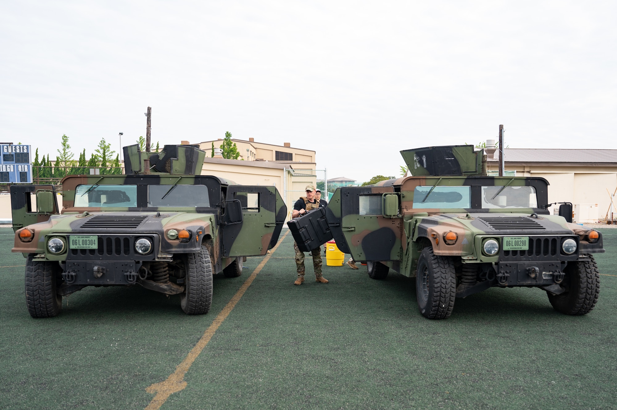 Tech. Sgt. Blaytin Southerly, 8th Security Forces Squadron command support staff section chief, carries a weighted pelican case from one Humvee to another during a Defenders’ Challenge for the 2023 National Police Week at Kunsan Air Base, Republic of Korea, May 25, 2023. A Defender created the challenge to test fellow members’ abilities to tackle obstacles they could encounter while on duty. (U.S. Air Force photo by Staff Sgt. Sadie Colbert)