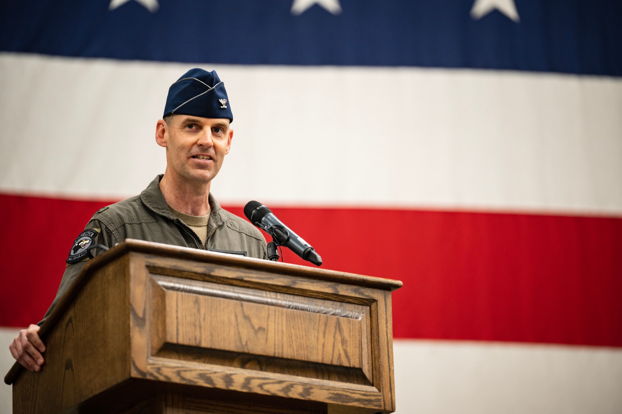 New commander speaks into microphone.