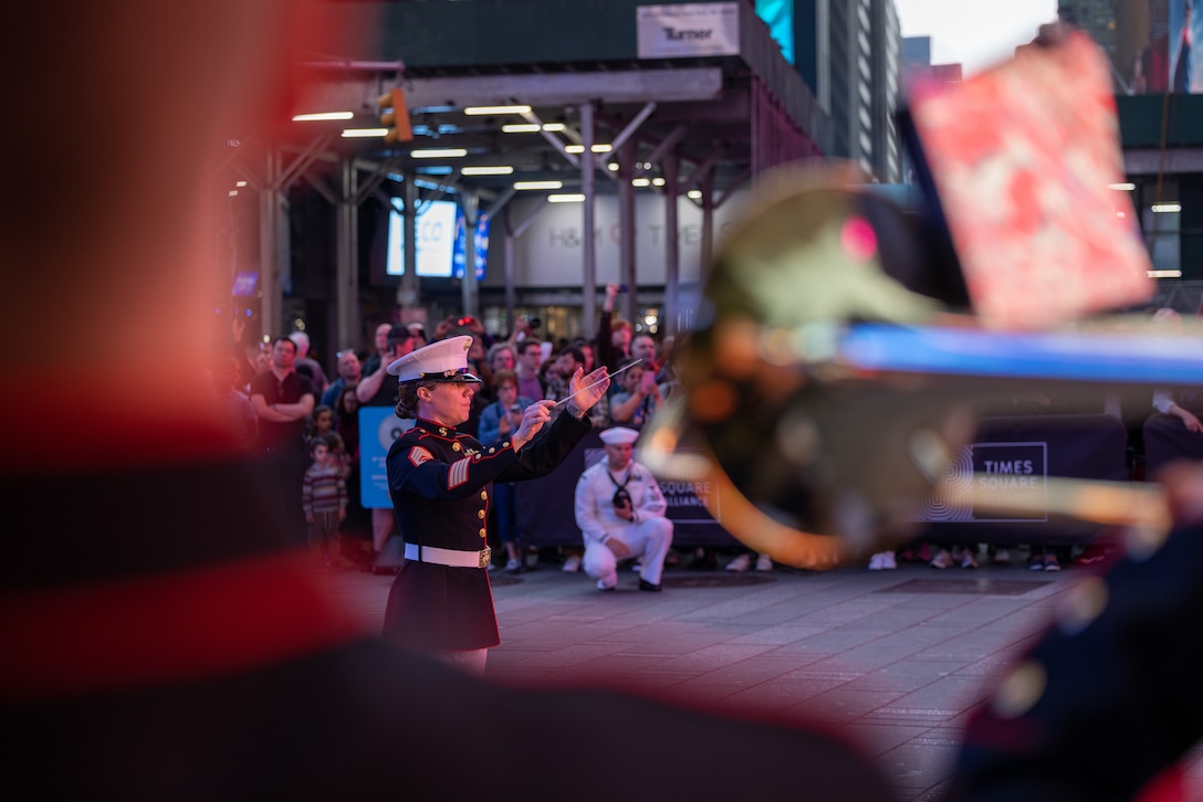 Gunnery Sgt. Anna H. Henrickson, band director, conducts the Quantico Marine Band at their performance at Times Square, N.Y. during the first day of Fleet Week New York (FWNY), May 24, 2023. More than 3,000 service members from the Marine Corps, Navy and Coast Guard and our NATO allies from Great Britain, Italy and Canada are engaging in special events throughout New York City and the surrounding Tri-State Region during FWNY 2023, showcasing the latest capabilities of today’s maritime services and connecting with citizens. The events include free public ship tours, military static displays, and live band performances and parades. (U.S. Marine Corps photo by Sgt. Juan Carpanzano)