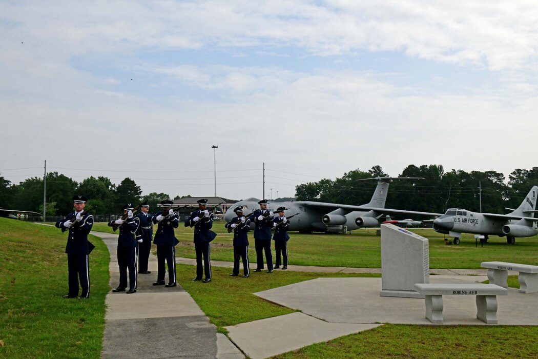 A group of people in military uniform shooting their rifles