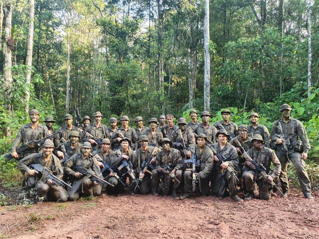 U.S. Marines with 1st Battalion, 2nd Marine Regiment, 2nd Marine Division (MARDIV) pose for a photo with their Dutch counterparts during a training exercise in the Suriname jungle, May 16, 2023.