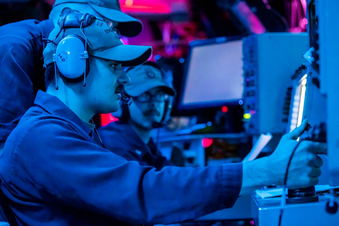 Sailors prepares to fire a ship’s five-inch cannon.