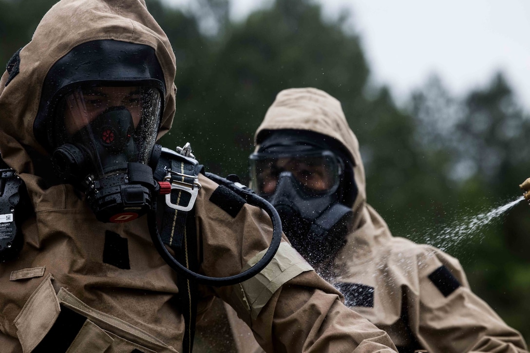 U.S. Marines with the 26th Marine Expeditionary Unit (26 MEU) conduct decontamination during a full mission profile event in a Chemical, Biological, Radiological, Nuclear (CBRN) hazard course in Perry, Georgia, May 19, 2023. During this course, the Marines have conducted scenario based training, chemical sampling, radiation dose mapping, wide area searches and tactical casualty response and recovery drills. (U.S. Marine Corps photo by Cpl. Aziza Kamuhanda)