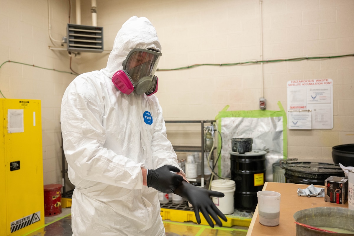 Staff Sgt. Tanner Tschann, a 934th  Maintenance Squadron aircraft structural maintenance technician, dons protective gear in preparation for painting aircraft parts at the Minneapolis-St. Paul Air Reserve Station, Minnesota, May 6, 2023. This gear must be worn before mixing paint and sealer together to be applied onto the parts. (U.S. Air Force photo by Senior Airman Colten Tessness)
