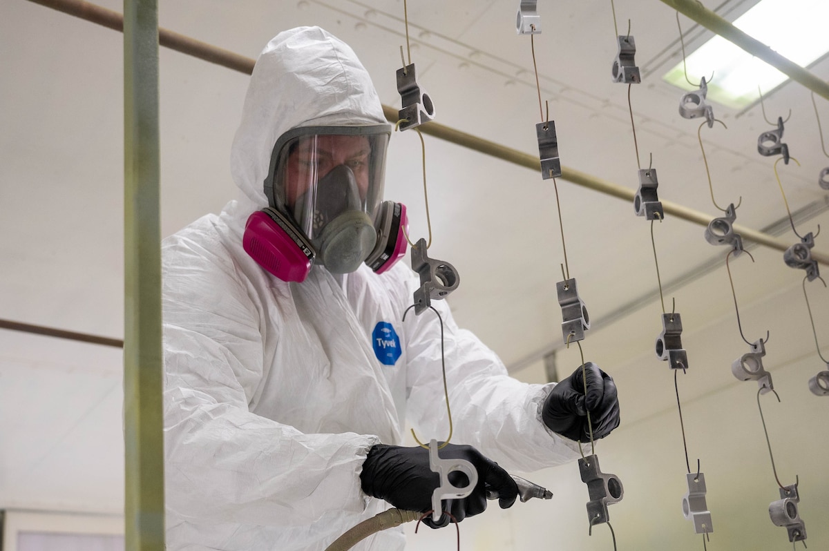 Staff Sgt. Tanner Tschann, 934th Maintenance Squadron aircraft structural maintenance technician, air blasts aircraft parts at the Minneapolis-St. Paul Air Reserve Station, Minnesota, May 6, 2023. This step in the paint application process is to ensure parts are cleared of debris so the paint solution will coat properly. (U.S. Air Force photo by Senior Airman Colten Tessness)