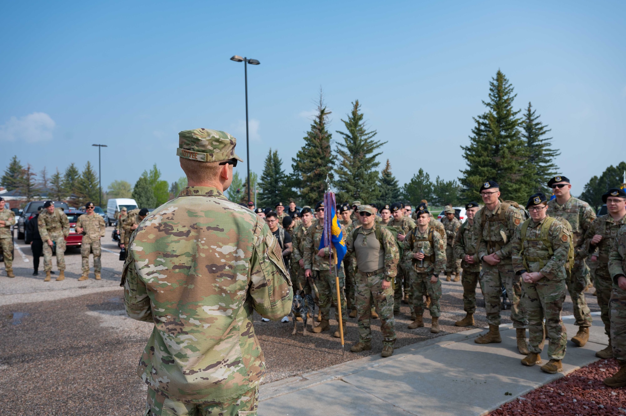 someone speaking to the crowd at the beginning of a ruck march,