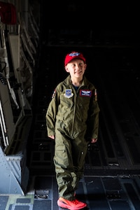 Owen Zobel, Team McChord’s newest pilot, tours a C-17 Globemaster III while taking part in the 4th Airlift Squadron’s Pilot for a Day program at Joint Base Lewis-McChord, Washington, May 11, 2023. The goal of the Pilot for a Day program is to provide children and their families in the local community who have catastrophic illnesses a once in a lifetime opportunity; the child is issued a flight suit and visits different mission sets around base such as the Security Forces Squadron Working Dog compound, the Fire Department, and a tour of the Air Traffic Control Tower and a C-17 Globemaster III. (U.S. Air Force photo by Staff Sgt. Rachel Williams)