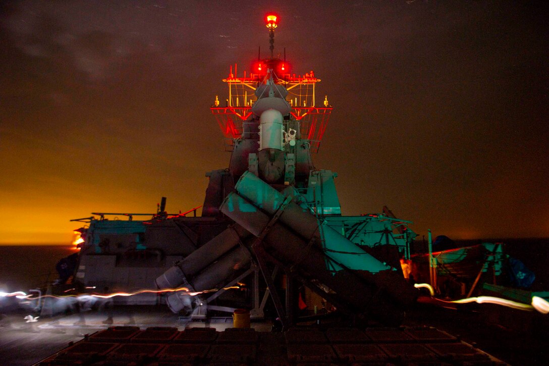 The mast of a ship at night.