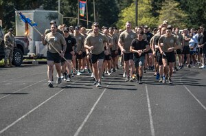 U.S. Air Force Tactical Air Control Party Airmen with the 5th Air Support Operations Squadron and additional Team McChord Airmen begin the first lap to kick-off the annual 24-hour TACP Run at Joint Base Lewis-McChord, Washington, May 12, 2023. The event is held annually by TACP units across the Air Force in honor of those who have fallen in the line of duty and raises awareness for Gold Star families. This year, a total of 812 miles were ran, 299 were walked or rucked and over $1,300 in donations were raised. (U.S. Air Force photo by Airman 1st Class Kylee Tyus)