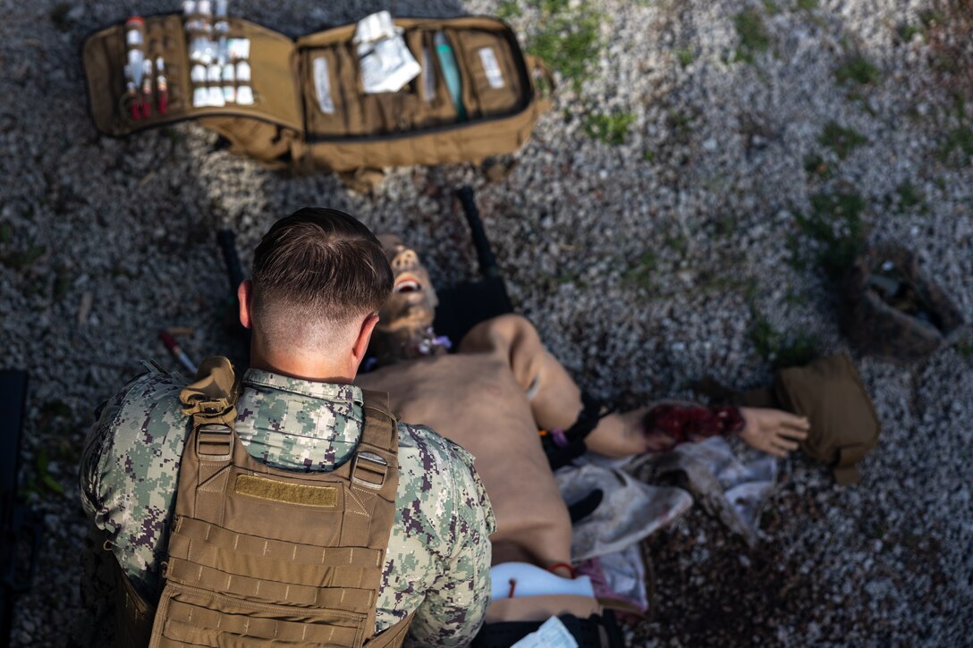 U.S. Navy Hospital Corpsman HM2 C Wallace, with II Marine Expeditionary Force (II MEF), provides triage to a simulated casualty during a Tactical Combat Casualty Care (TCCC) Tier Three Instructor test at Battle Skills Training on Camp Lejeune, North Carolina, May 18, 2023. Sailors with 2nd Marine Logistics Group hosted a TCCC Tier Three instructor course for Corpsmen from around II MEF to become instructors. (U.S. Marine Corps photo by Lance Cpl. Christian Salazar)