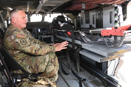 First Sgt. Patrick Casha, flight paramedic with the Oregon Army National Guard, demonstrates the new MH60M Medical Upgrade Interior kit designed for Future Long-Range Assault Aircraft during EDGE 23 Distinguished Visitor Day at Yuma Proving Ground, Arizona, May 18, 2023.
