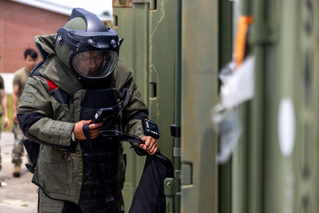 U.S. Marines with Marine Wing Support Squadron 271,  Marine Aircraft Group 14, 2D Marine Air wing, run through a bomb suit agility test during the Explosive Ordnance Disposal (EOD) Team of the Year Competition on Camp Lejeune, North Carolina, May 22, 2023. Marines of 8th Engineer Support Battalion hosted the joint competition of EOD teams from across the east coast, in order to test individual and team skills while enhancing camaraderie and Esprit de Corps across the EOD community. (U.S. Marine Corps photo by Lance Cpl. Christian Salazar)