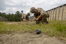 U.S. Army Sgt. Shannon Russell (left) and Spc. William Adalian with the 767th Explosive Ordnance Disposal Company, place detonation charges during the Explosive Ordnance Disposal (EOD) Team of the Year Competition on Camp Lejeune, North Carolina, May 23, 2023. Marines of 8th Engineer Support Battalion hosted the joint competition of EOD teams from across the east coast, in order to test individual and team skills while enhancing camaraderie and Esprit de Corps across the EOD community. (U.S. Marine Corps photo by Lance Cpl. Christian Salazar)