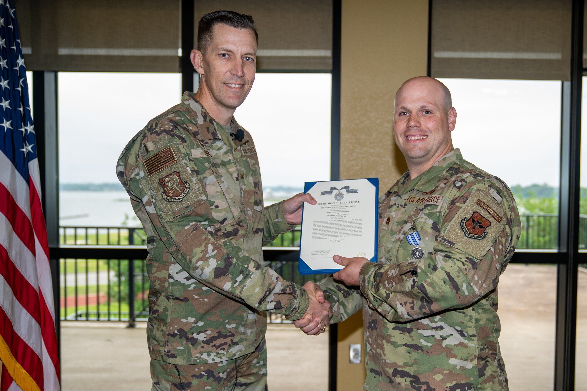 U.S. Air Force Col. Billy Pope, Jr., 81st Training Wing commander, awards Maj. Jake Pfannenstiel, 81st Force Support Squadron operations officer, the Air and Space Achievement medal at Keesler Air Force Base, Mississippi, May 24, 2023.