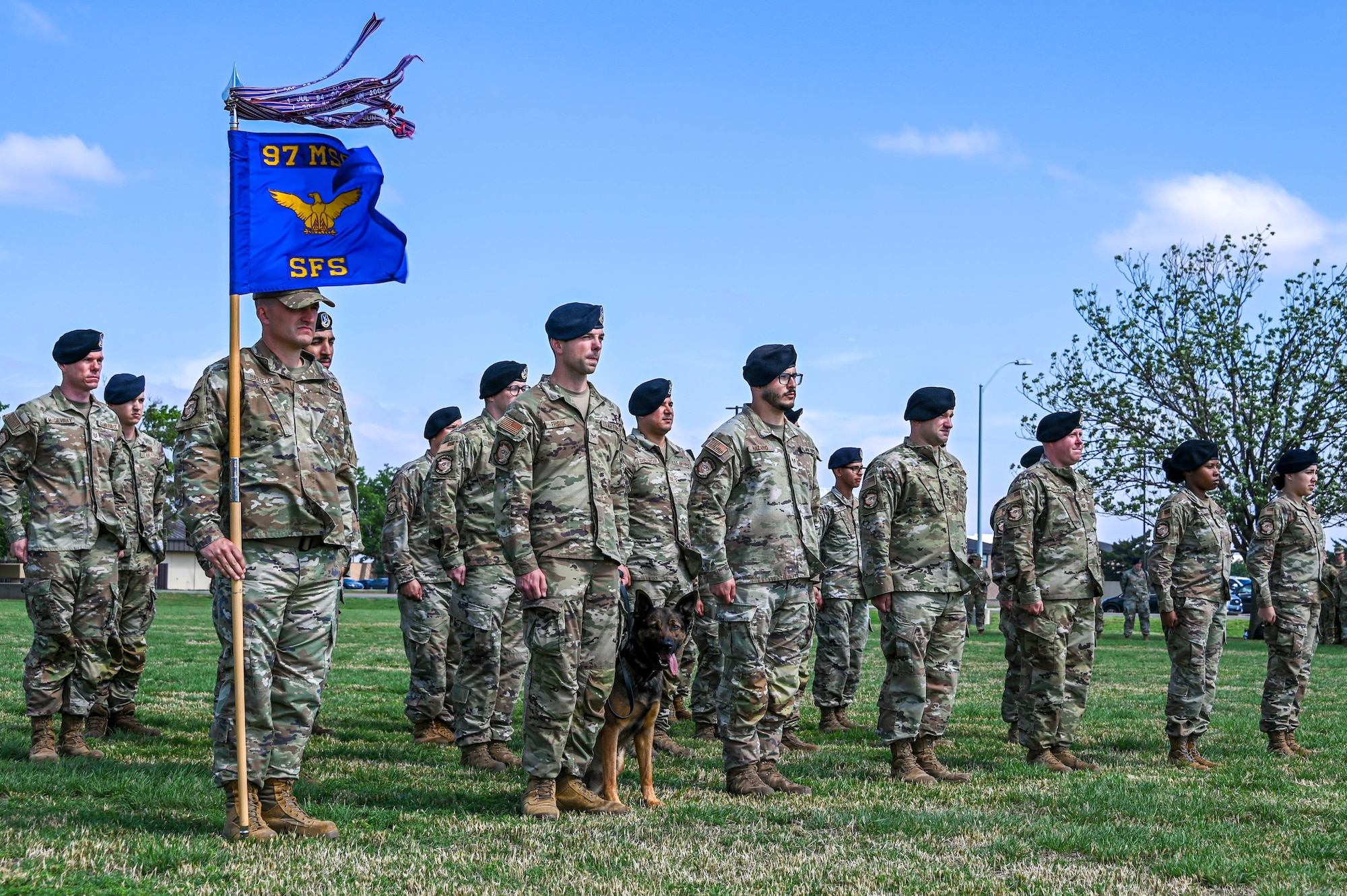 Defenders from the 97th Security Forces Squadron stand at attention during the playing of the national anthem at Altus Air Force Base (AFB), Oklahoma, May 19, 2023. During the ceremony, speeches were given by the Altus Police Department and Altus AFB defenders. (U.S. Air Force photo by Senior Airman Kayla Christenson)